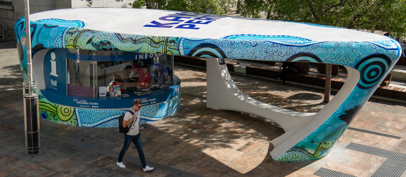 Information Kiosk worker giving two men perth tourist information.