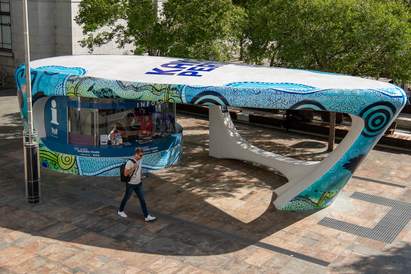 Information Kiosk worker giving two men perth tourist information.