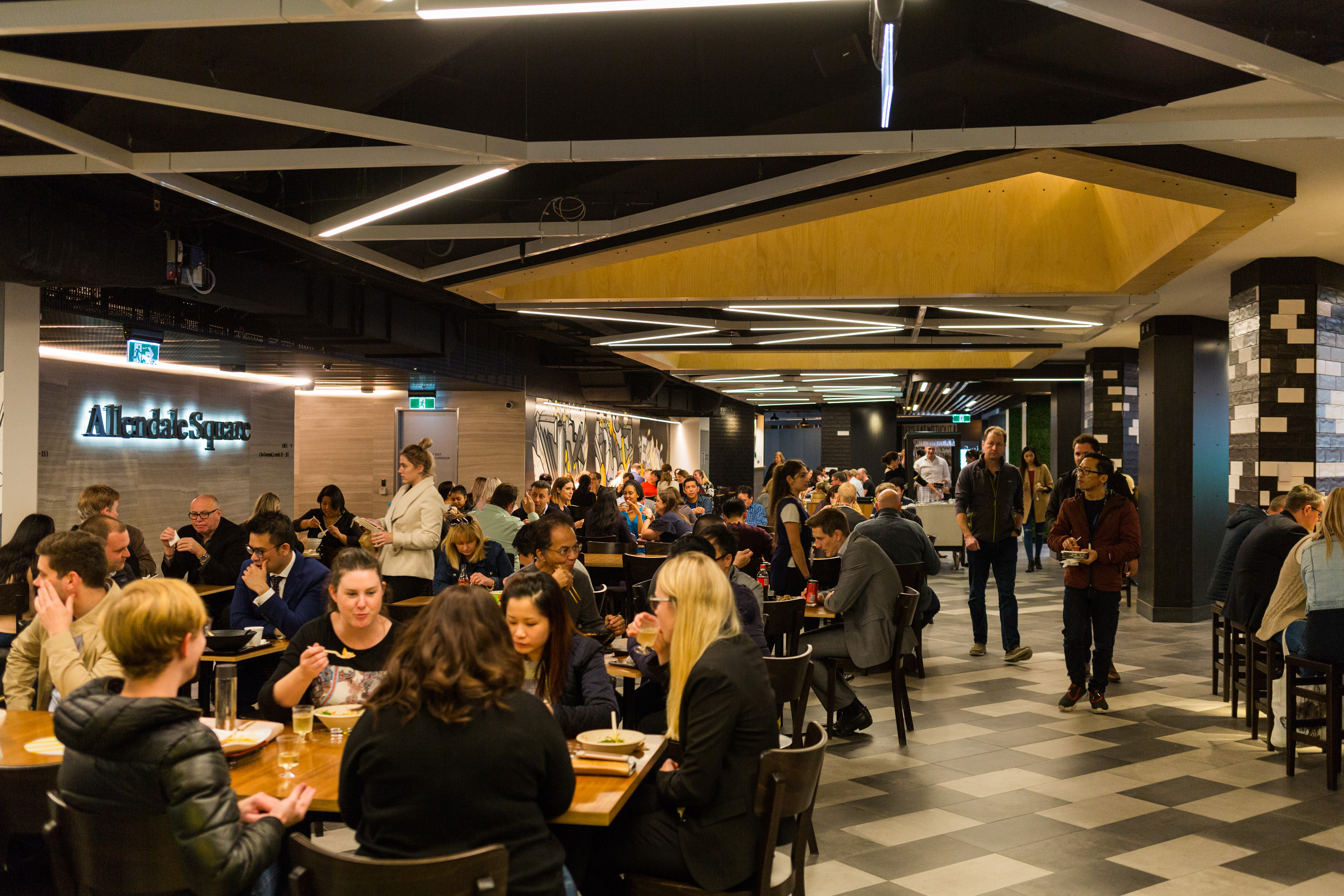 People eating lunch at tables in Allendale Square