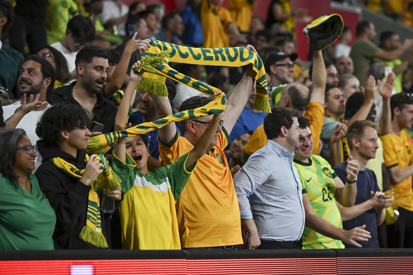 Football fans cheering on the Socceroos